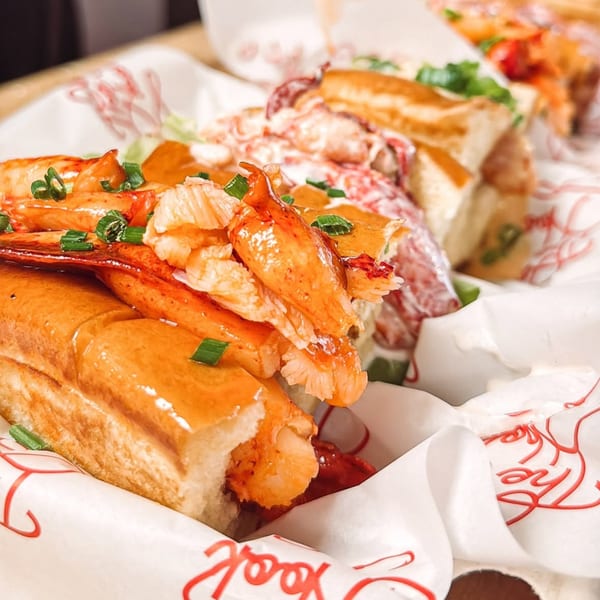 Two Off The Hook lobster rolls, one with buttered lobster, the other with creamy lobster salad.